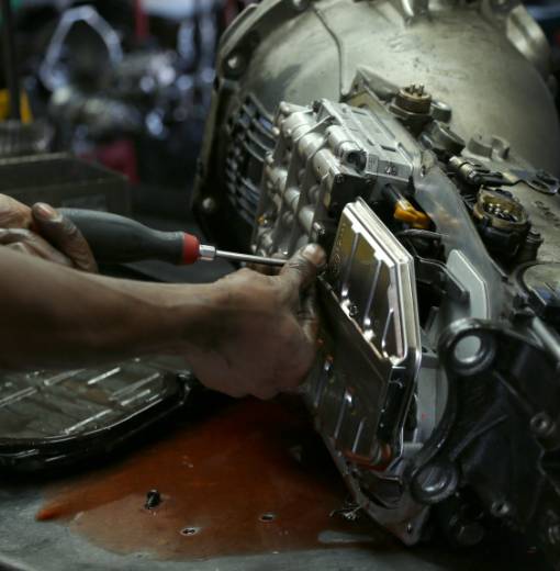 Mechanic working on car transmission