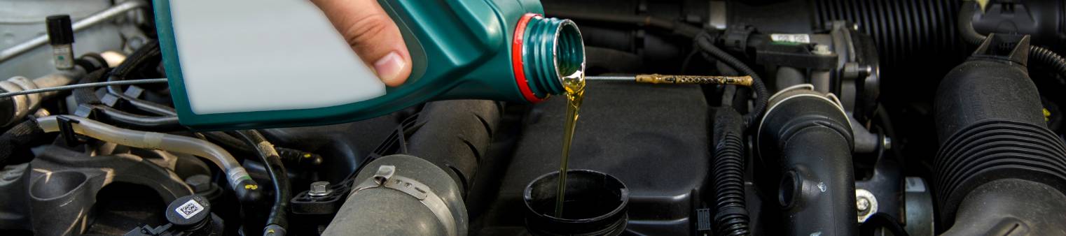 Someone Filling an oil to a car